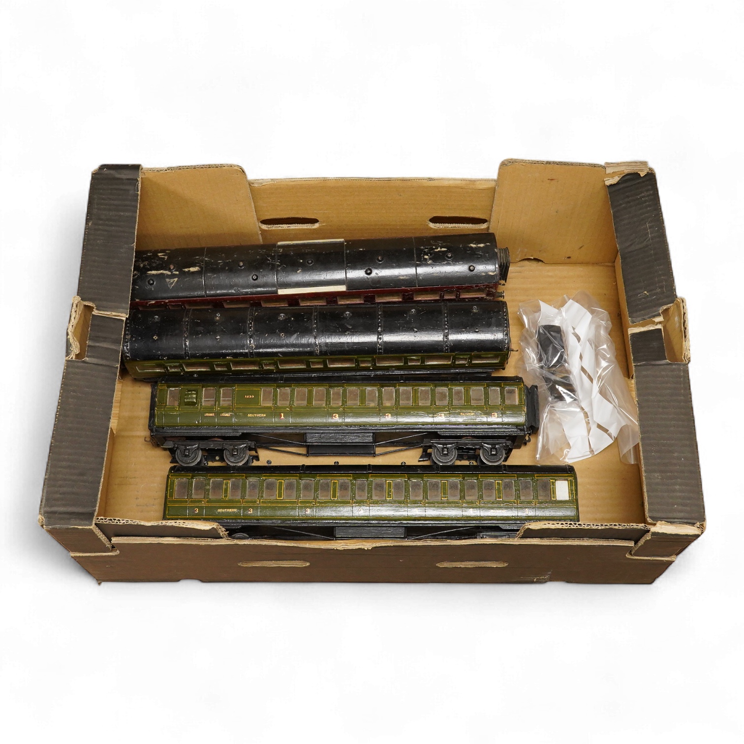 Four 0 gauge 1930s wooden Bonds bogie coaches; three Southern Railway; a Composite Brake, and two First Third Composites, and an LMS First Third Composite